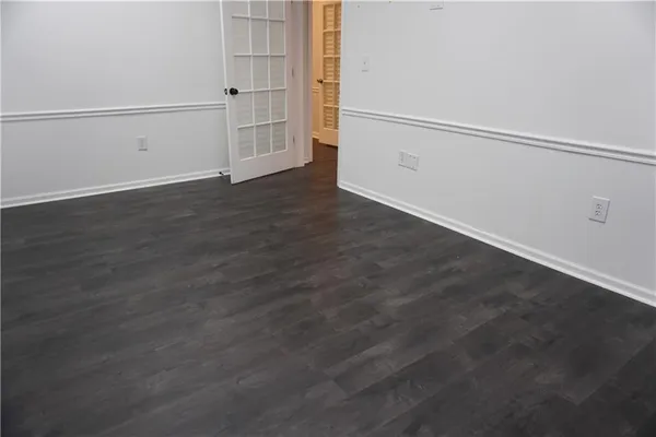 an empty room with wooden floor