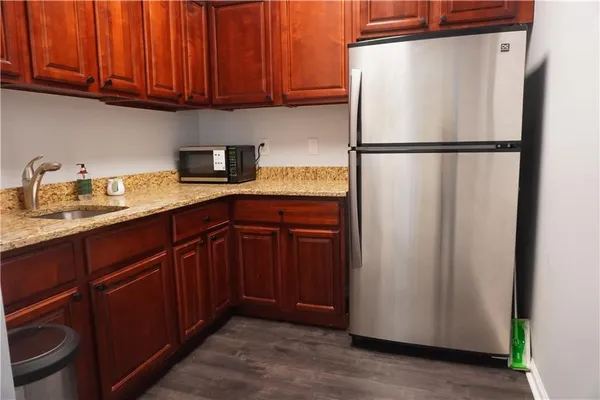 a kitchen with stainless steel appliances granite countertop a refrigerator and a sink