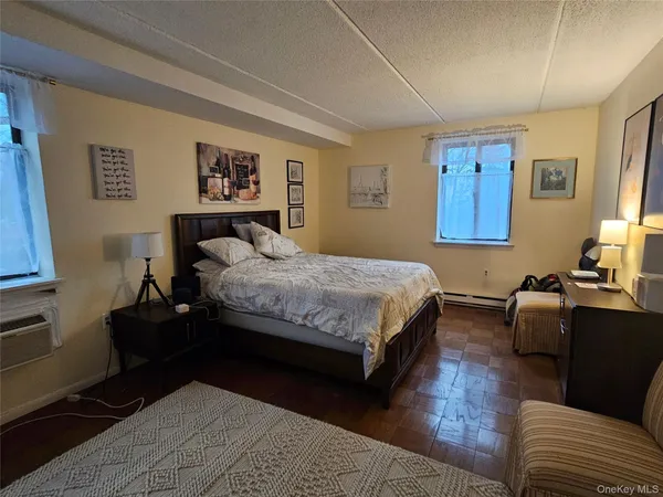 a bedroom with a bed couch and a window