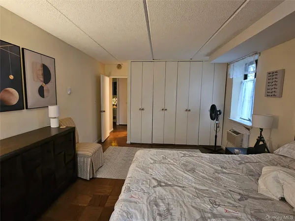 a bed room with a bed and a flat tv screen on dresser