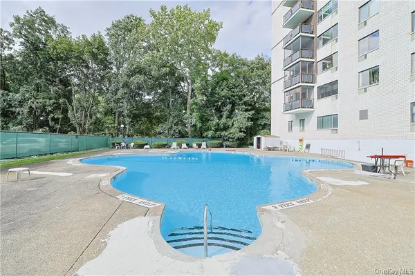 a view of a swimming pool with a patio