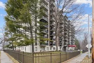 a view of a brick building next to a yard