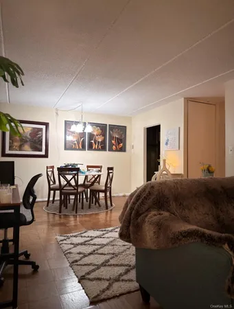 a living room with furniture a dining table and a flat screen tv