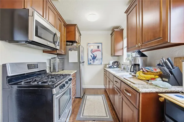 a kitchen with stainless steel appliances granite countertop a stove and a sink