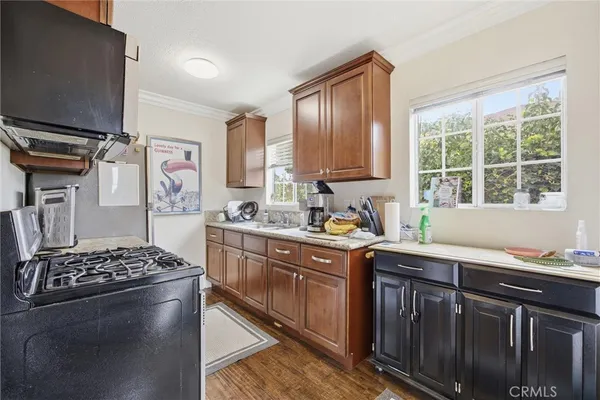 a kitchen with stainless steel appliances kitchen island granite countertop a sink stove and refrigerator