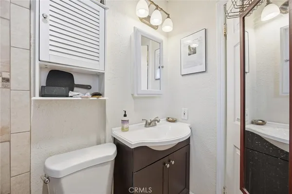 a bathroom with a sink toilet and vanity