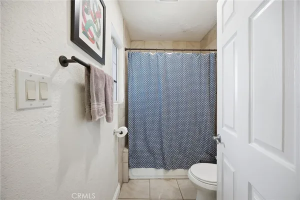 a bathroom with a shower toilet and sink