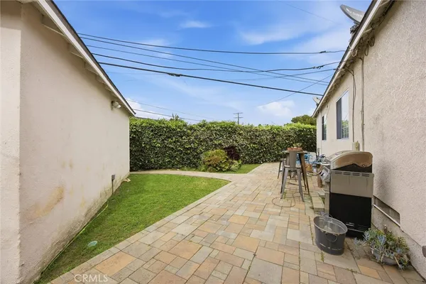 a view of a patio with a table and chairs and potted plants