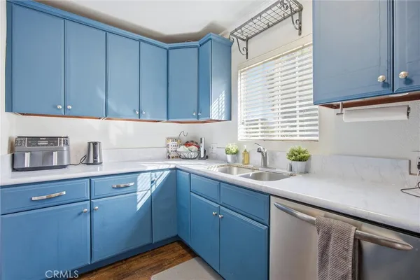 a kitchen with a sink cabinets and window
