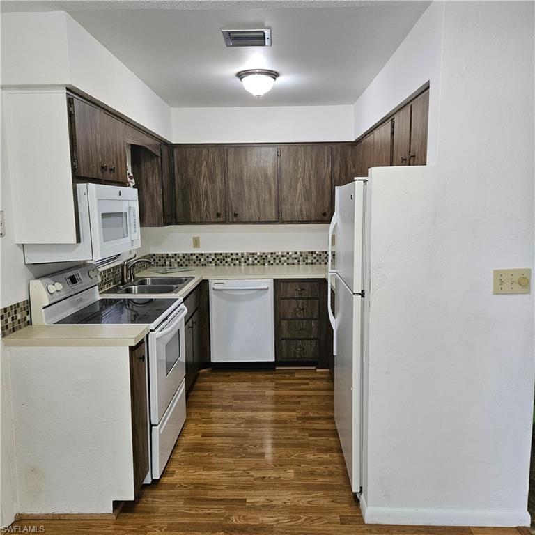 a kitchen with a stove a refrigerator and a sink
