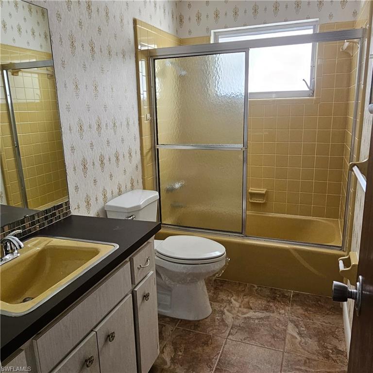 317 Maycrest Road Lehigh Acres, FL 33936 - Photo 4 of 5 a bathroom with a sink a toilet and shower