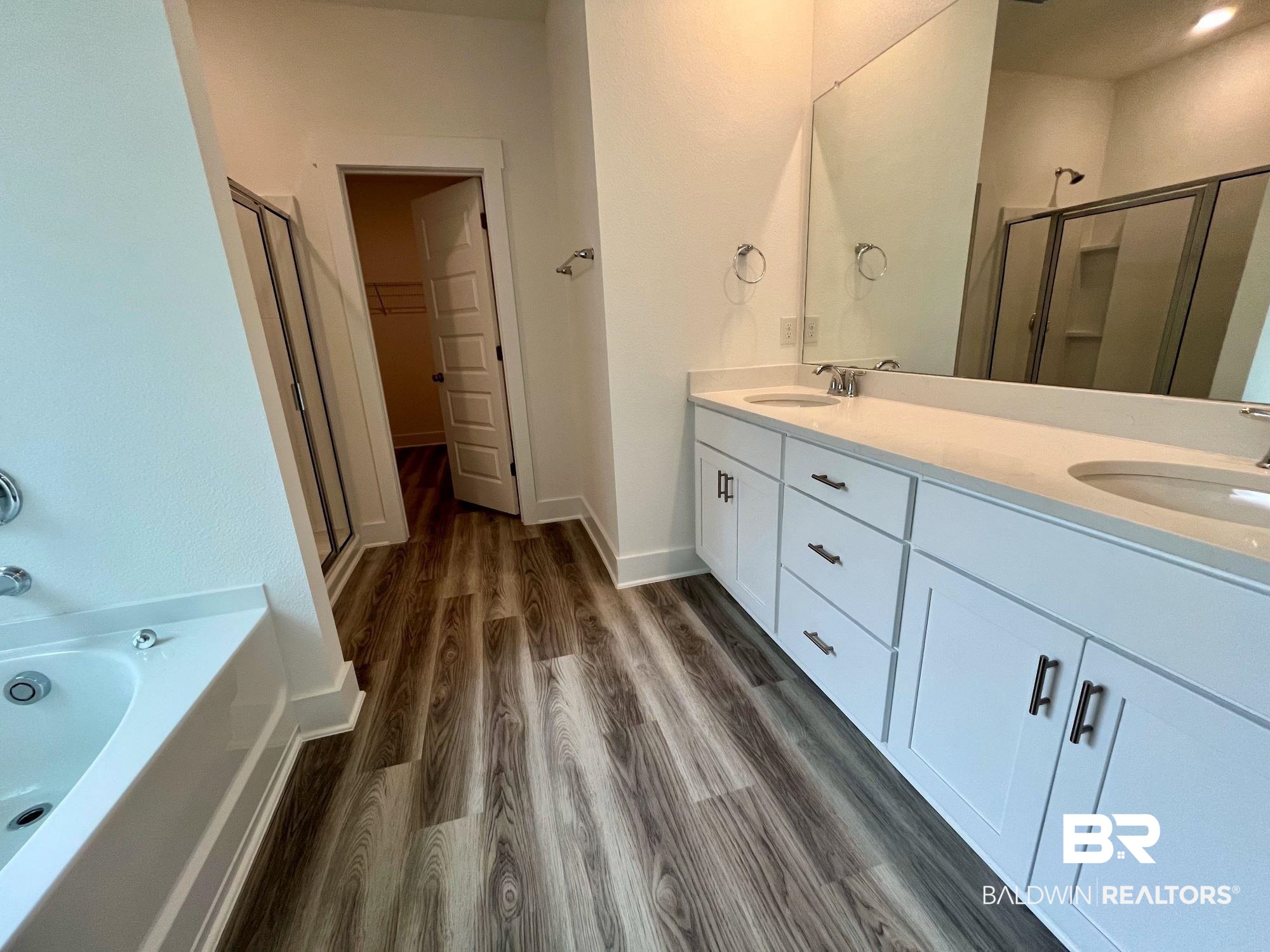 334 Barndling Street Fairhope, AL 36532 - Photo 27 of 34 Bathroom featuring vanity, hardwood / wood-style flooring, and plus walk in shower