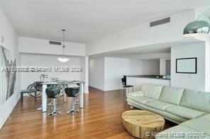 Edgewater Miami, FL 33132 - Photo 6 of 6 a living room with furniture and a chandelier