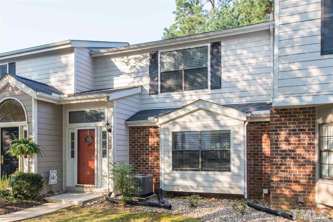 7615 Falcon Rest Circle, Unit 7615 Raleigh, NC 27615 - Photo 2 of 26 a view of a brick house with plants and large windows