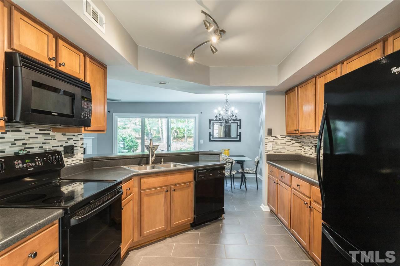 7615 Falcon Rest Circle, Unit 7615 Raleigh, NC 27615 - Photo 18 of 26 a kitchen with stainless steel appliances granite countertop a sink stove and refrigerator