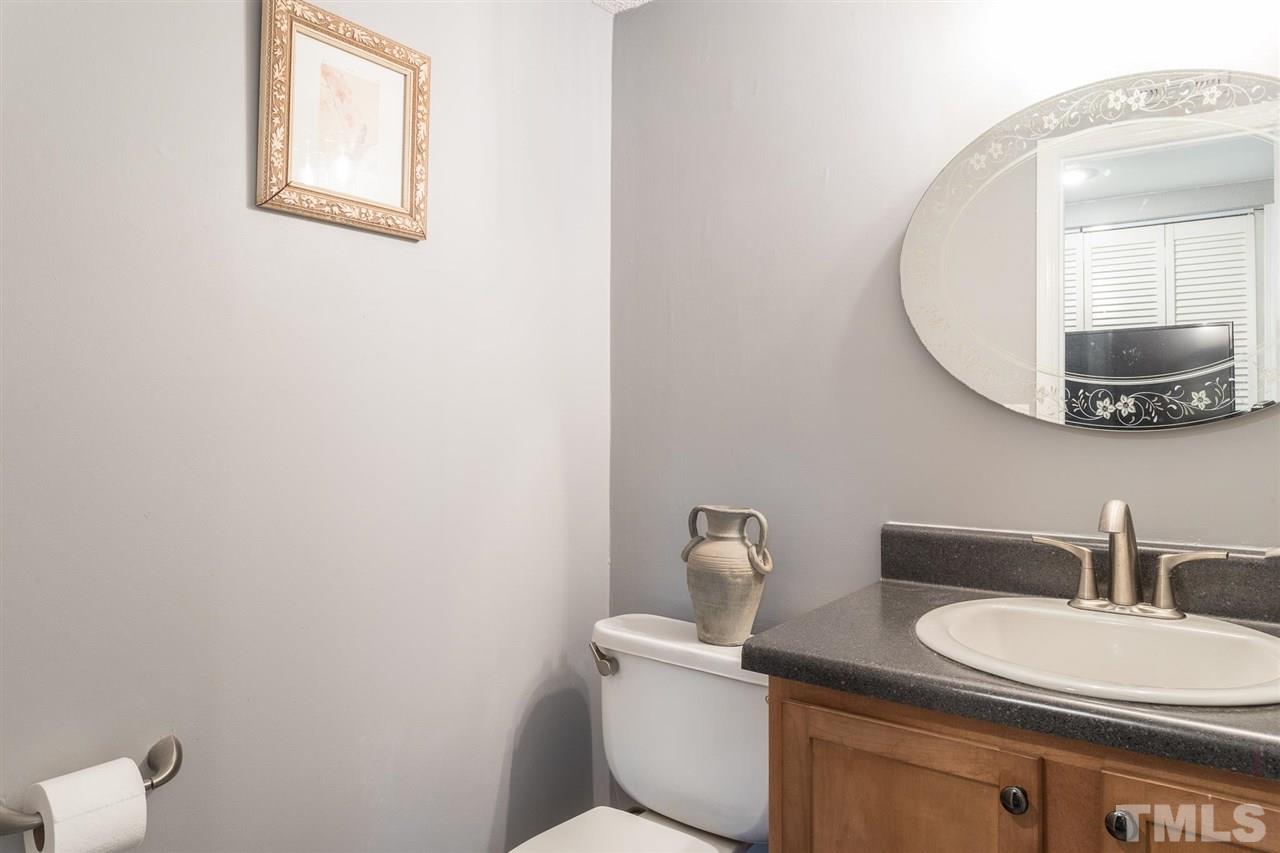 7615 Falcon Rest Circle, Unit 7615 Raleigh, NC 27615 - Photo 21 of 26 a bathroom with a toilet a sink and mirror