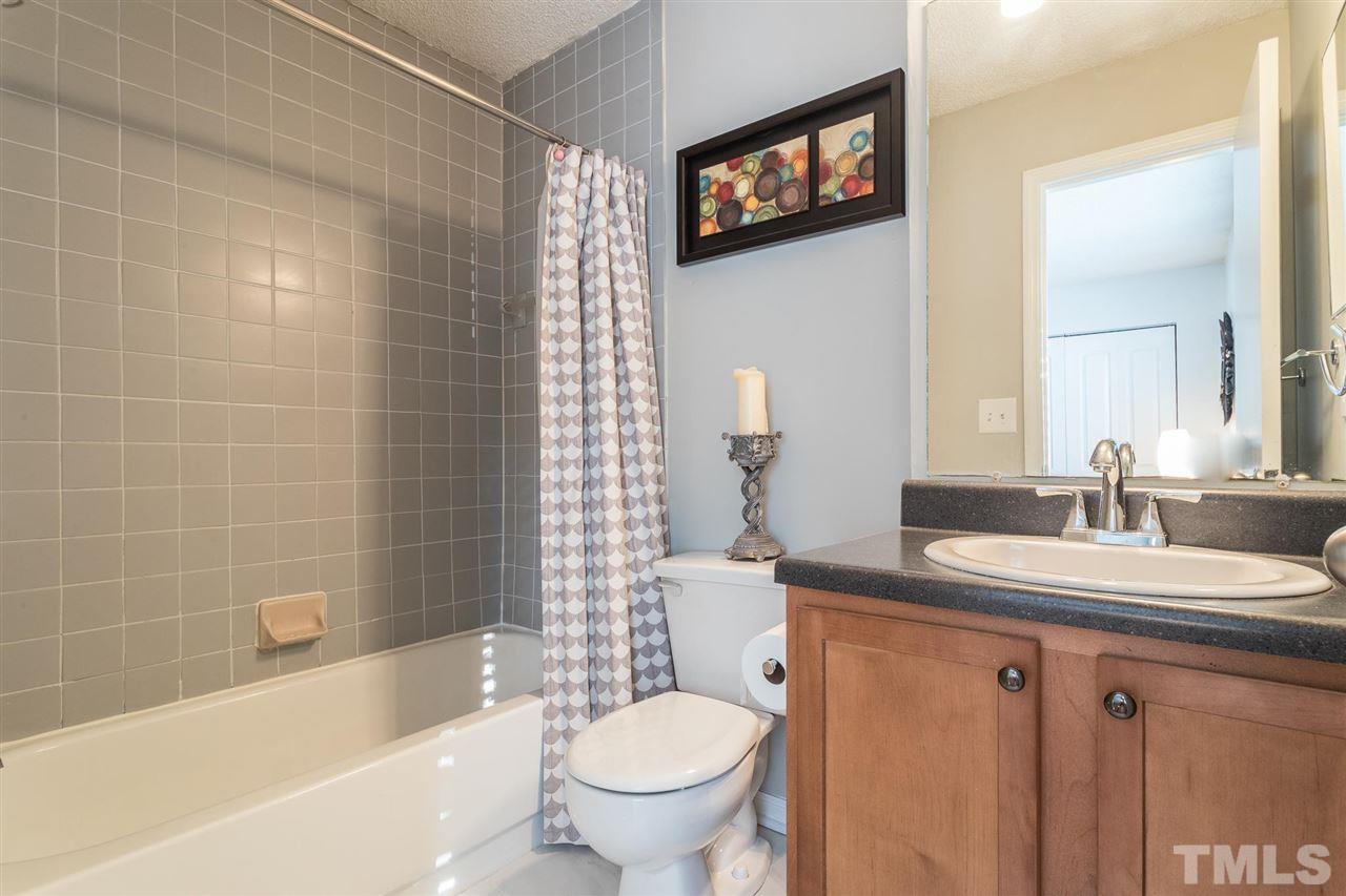 7615 Falcon Rest Circle, Unit 7615 Raleigh, NC 27615 - Photo 26 of 26 a bathroom with a granite countertop sink toilet and shower