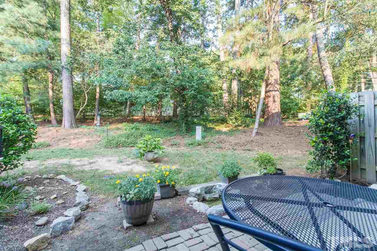 7615 Falcon Rest Circle, Unit 7615 Raleigh, NC 27615 - Photo 7 of 26 a view of backyard with deck and outdoor seating