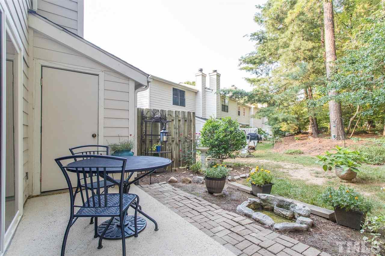 7615 Falcon Rest Circle, Unit 7615 Raleigh, NC 27615 - Photo 8 of 26 a view of a patio with table and chairs and potted plants