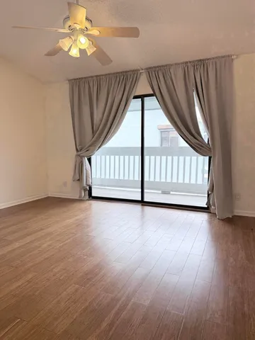 an empty room with windows & stairs