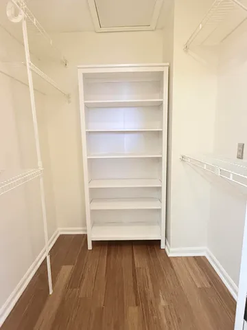 a view of walk in closet with empty racks