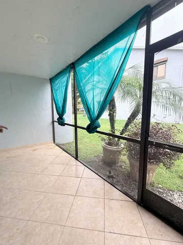 a view of empty room with a large window