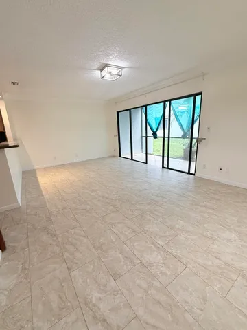 an empty room with windows and pool view
