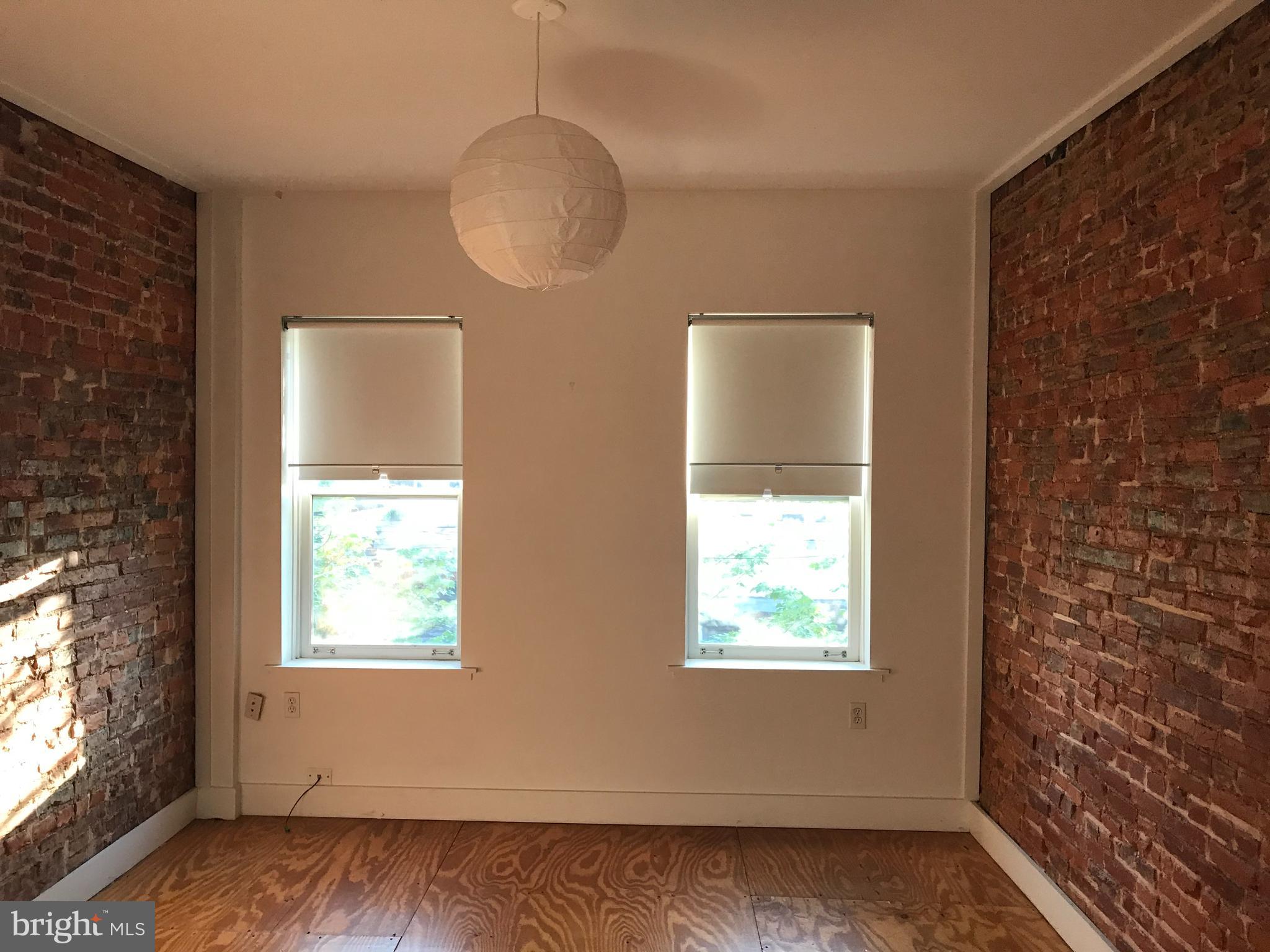 523 Budd Street Philadelphia, PA 19104 - Photo 22 of 48 an empty room with wooden floor and windows