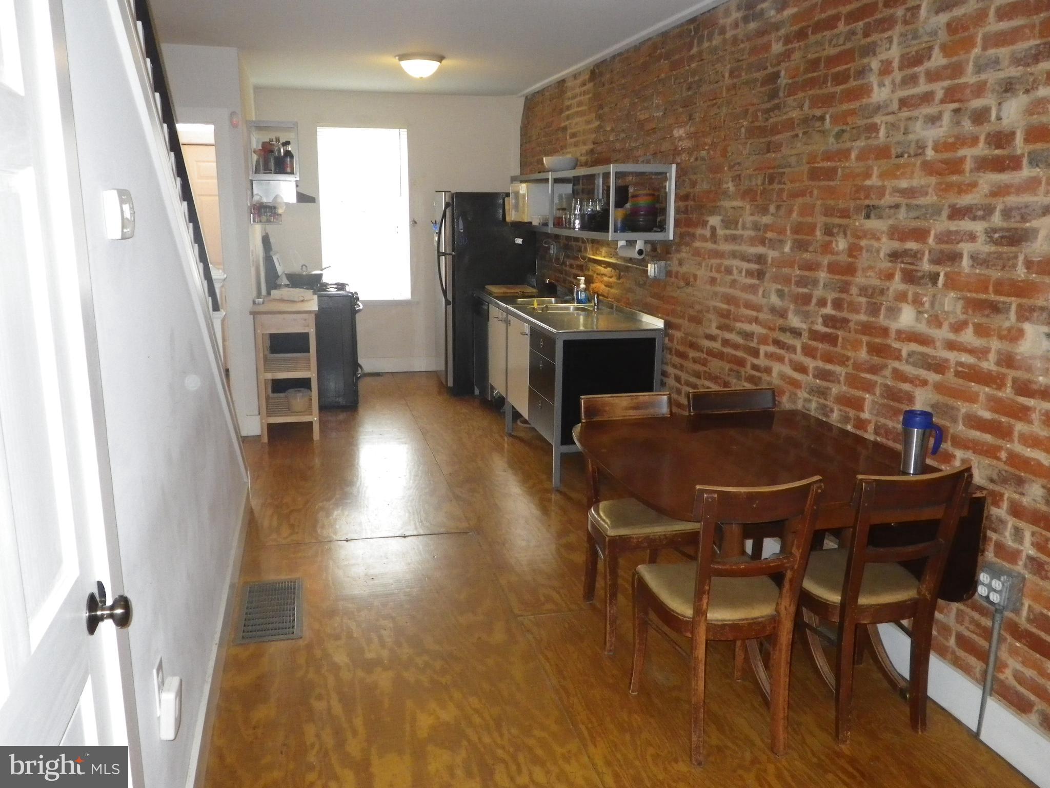 523 Budd Street Philadelphia, PA 19104 - Photo 7 of 48 a kitchen with stainless steel appliances kitchen island granite countertop a table chairs and a refrigerator