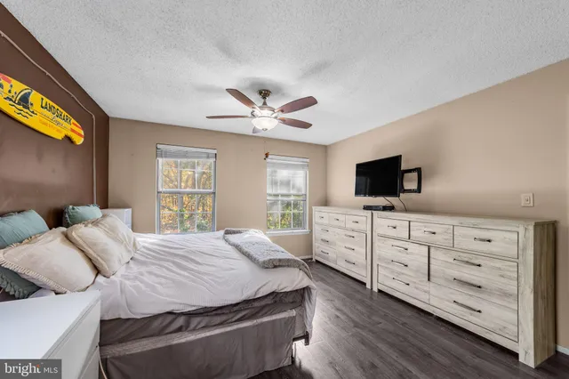 a bedroom with a large bed and a tv