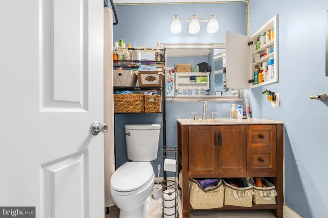 a bathroom with a toilet sink and mirror