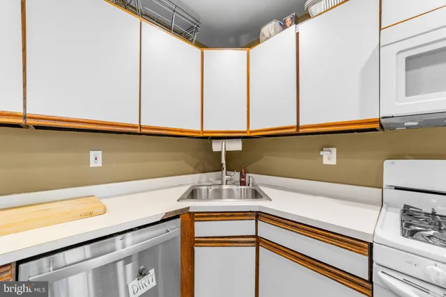 a view of a kitchen with a sink and cabinets