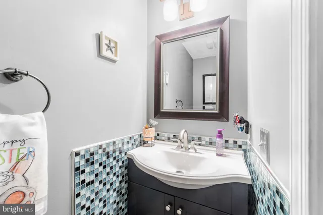 a bathroom with a sink vanity and a mirror