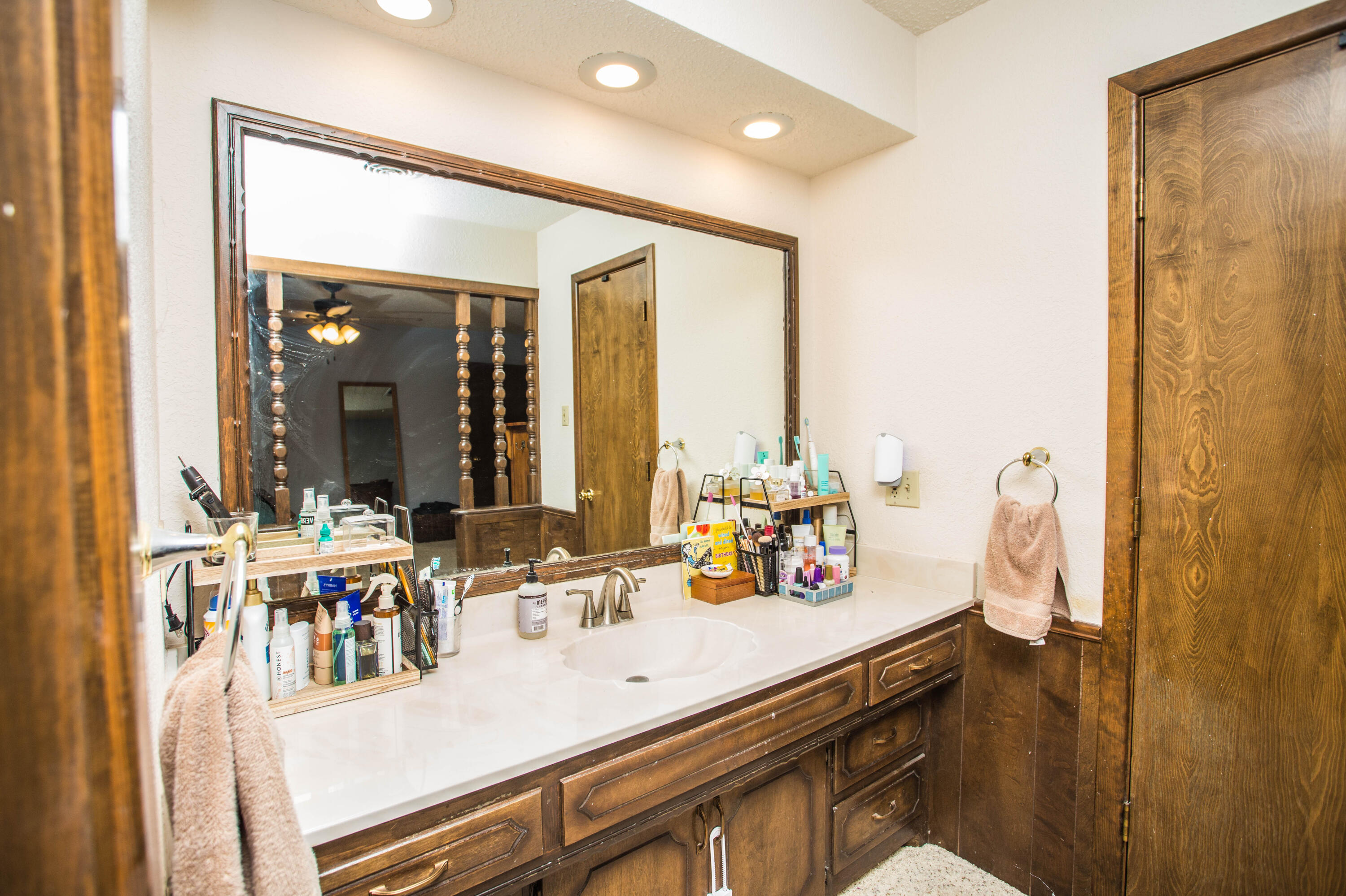 705 South 22nd Street Slaton, TX 79364 - Photo 18 of 30 a bathroom with a double vanity sink and a mirror