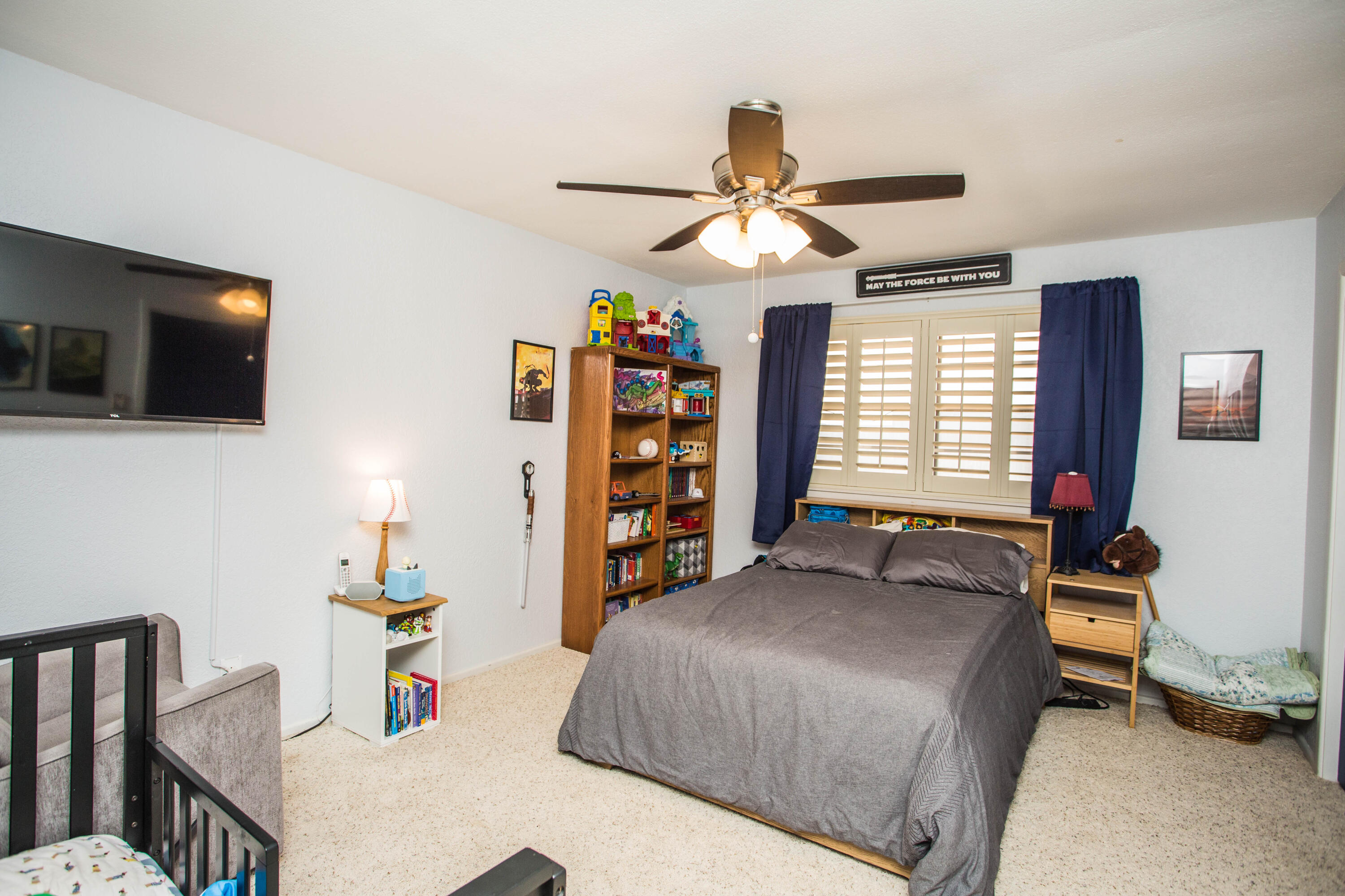 705 South 22nd Street Slaton, TX 79364 - Photo 20 of 30 a bedroom with a bed and a flat screen tv