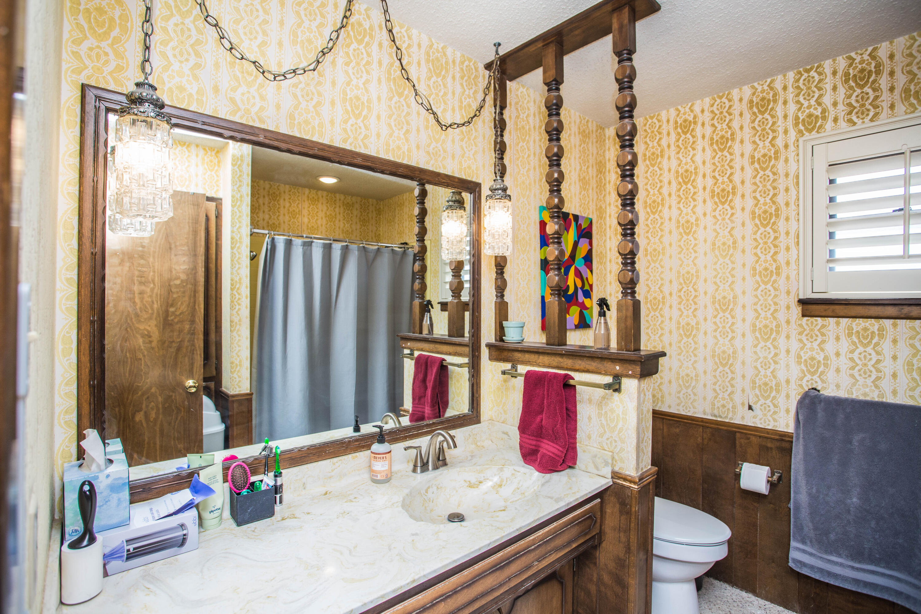 705 South 22nd Street Slaton, TX 79364 - Photo 21 of 30 a bathroom with a sink vanity mirror and toilet