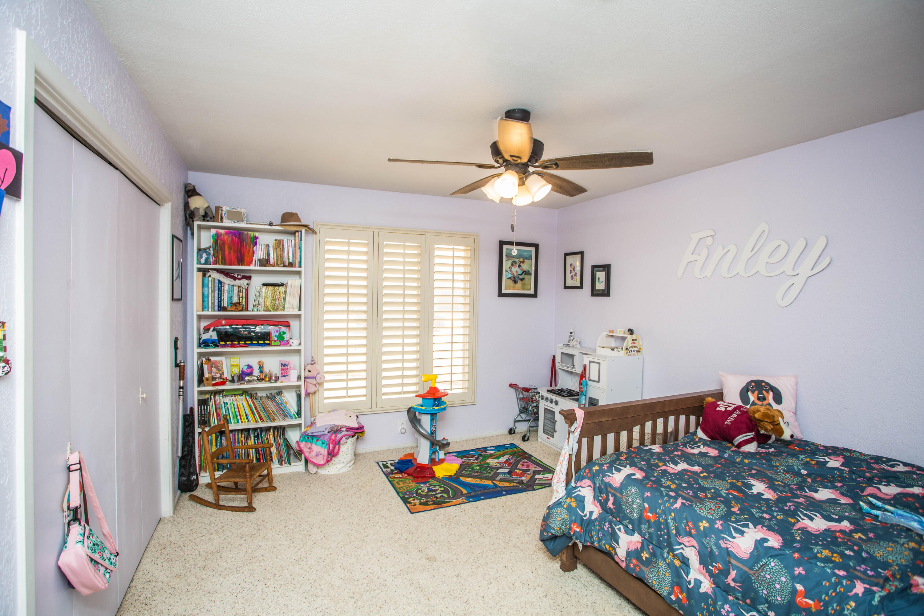 705 South 22nd Street Slaton, TX 79364 - Photo 23 of 30 a bedroom with furniture and a book shelf
