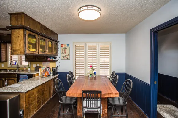 a view of a dining room with furniture a chandelier and wooden floor