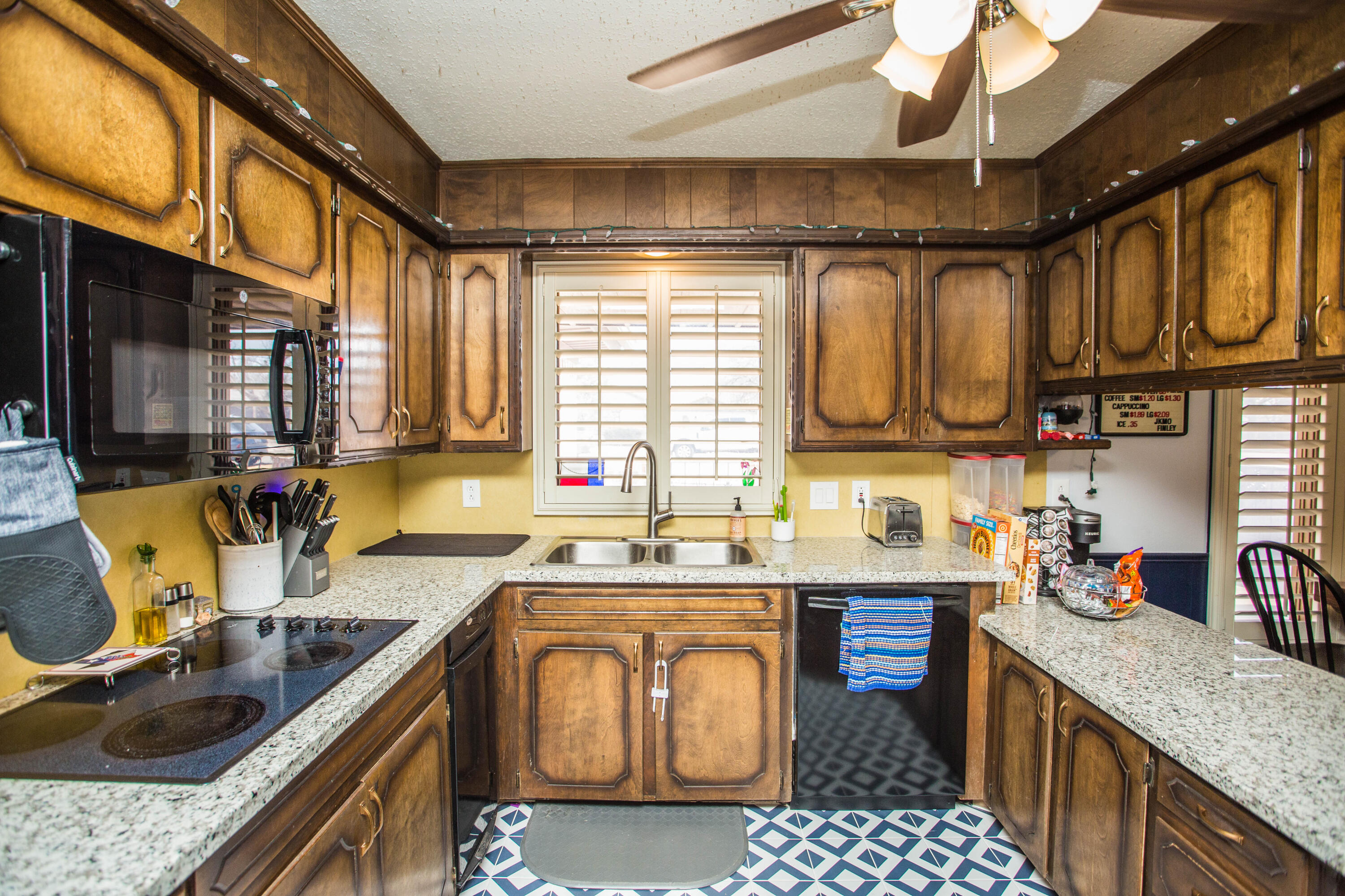 705 South 22nd Street Slaton, TX 79364 - Photo 7 of 30 a kitchen with stainless steel appliances granite countertop a sink a stove top oven a chimney a counter space and a sink