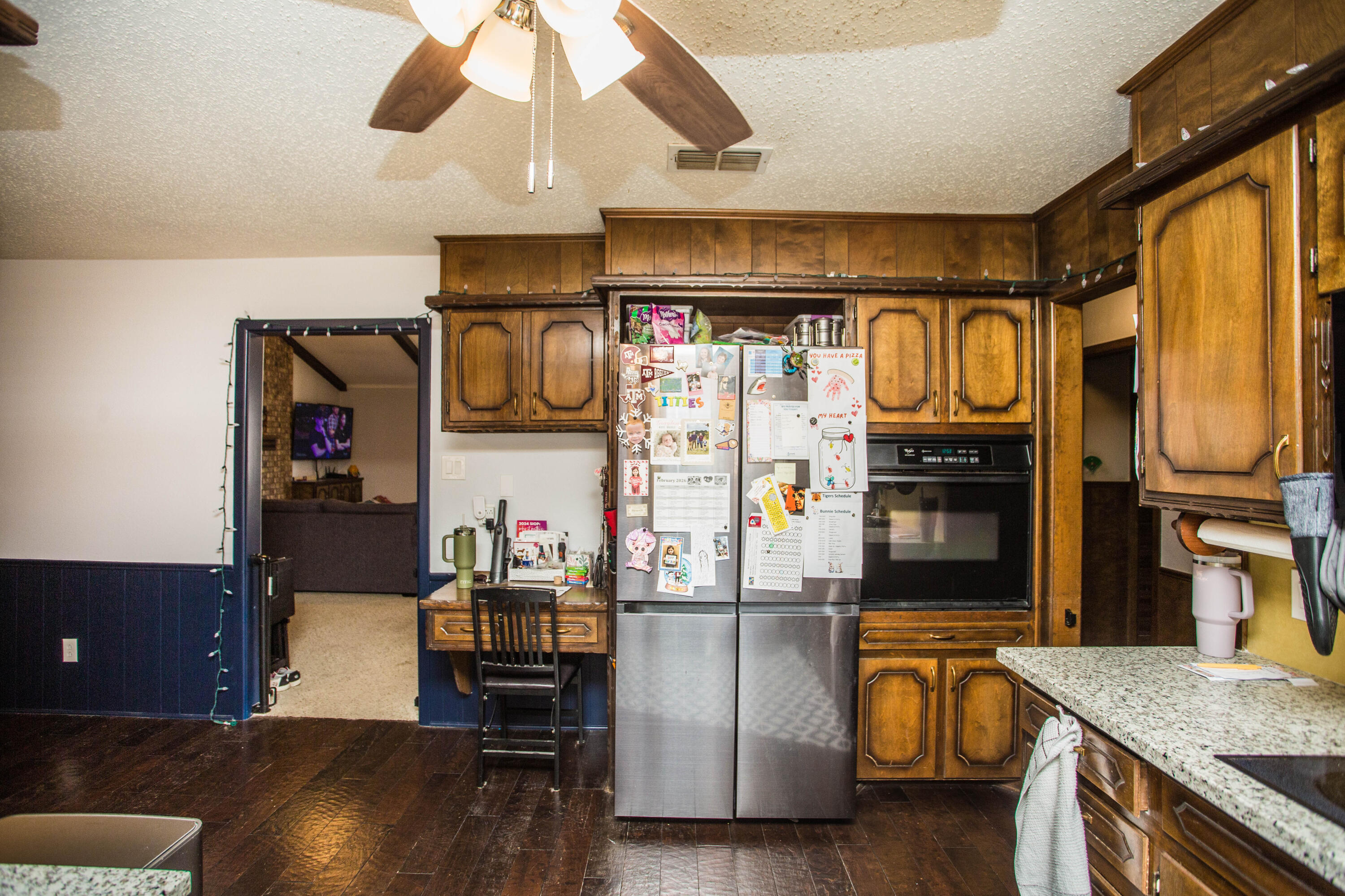 705 South 22nd Street Slaton, TX 79364 - Photo 9 of 30 a kitchen with stainless steel appliances granite countertop a sink and a refrigerator