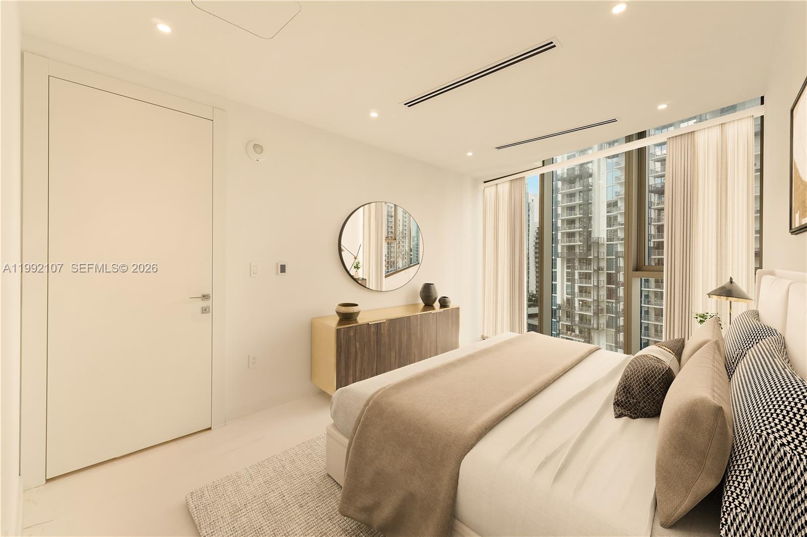 300 Biscayne Blvd Way, Unit 2103C Miami, FL 33131 - Photo 28 of 41 a bedroom with a large bed and a chandelier
