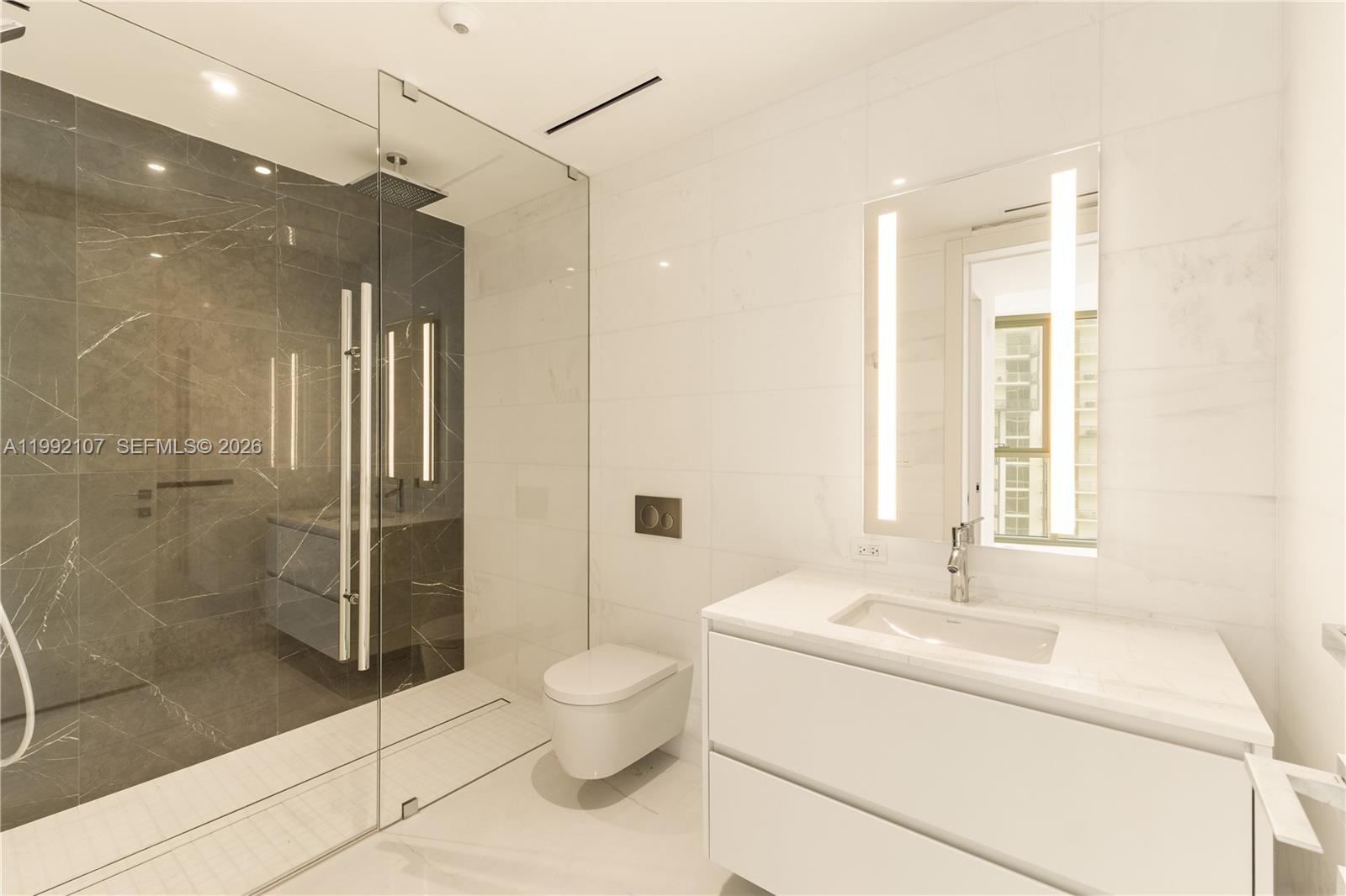300 Biscayne Blvd Way, Unit 2103C Miami, FL 33131 - Photo 30 of 41 a bathroom with a bathtub shower sink and toilet