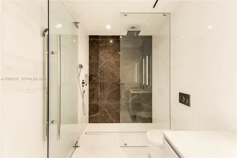 a bathroom with a shower and a sink