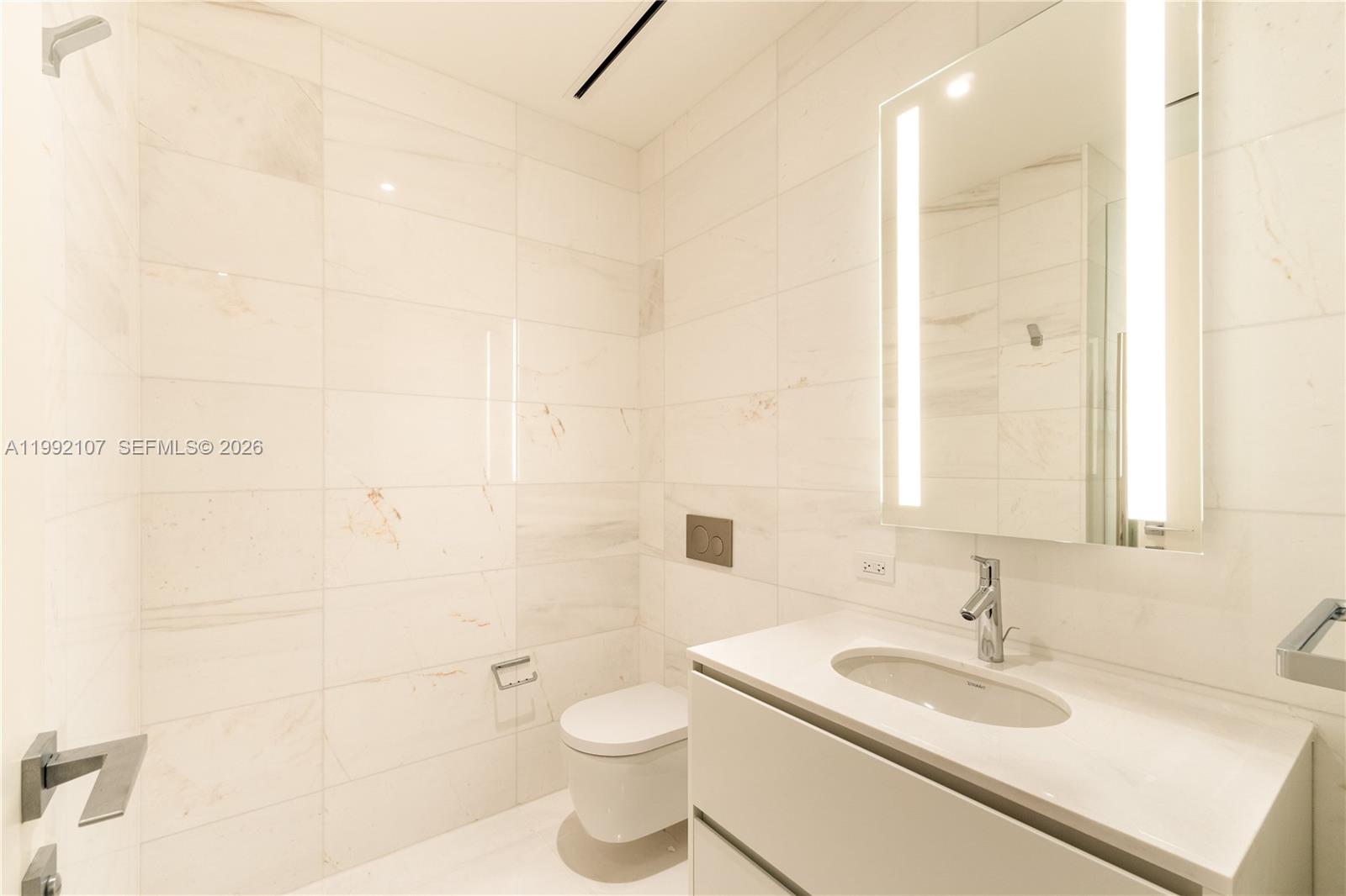 300 Biscayne Blvd Way, Unit 2103C Miami, FL 33131 - Photo 10 of 41 a bathroom with a sink a toilet and shower