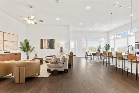 a living room with furniture or wooden floor and a chandelier