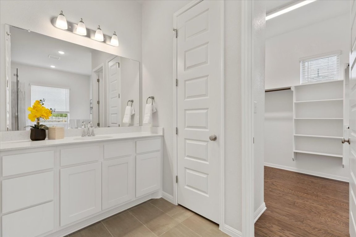 271 Eclipse Drive Austin, TX 78737 - Photo 15 of 39 a bathroom with a sink double vanity and a mirror