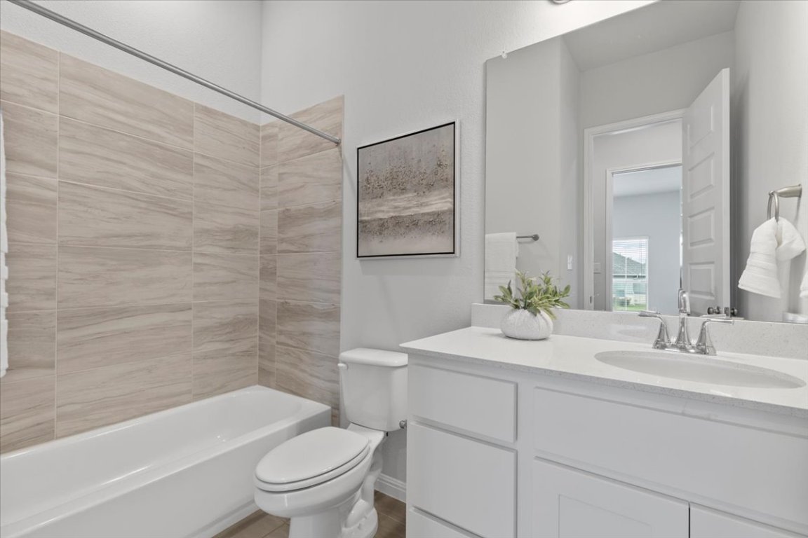 271 Eclipse Drive Austin, TX 78737 - Photo 26 of 39 a bathroom with a sink a toilet and shower