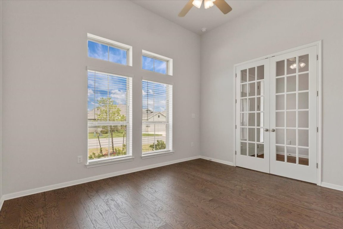 271 Eclipse Drive Austin, TX 78737 - Photo 27 of 39 an empty room with wooden floor and windows