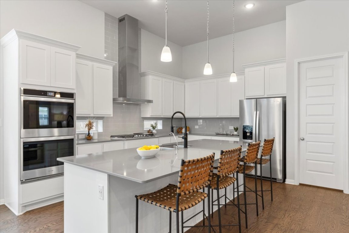 271 Eclipse Drive Austin, TX 78737 - Photo 5 of 39 a kitchen with a dining table chairs and refrigerator