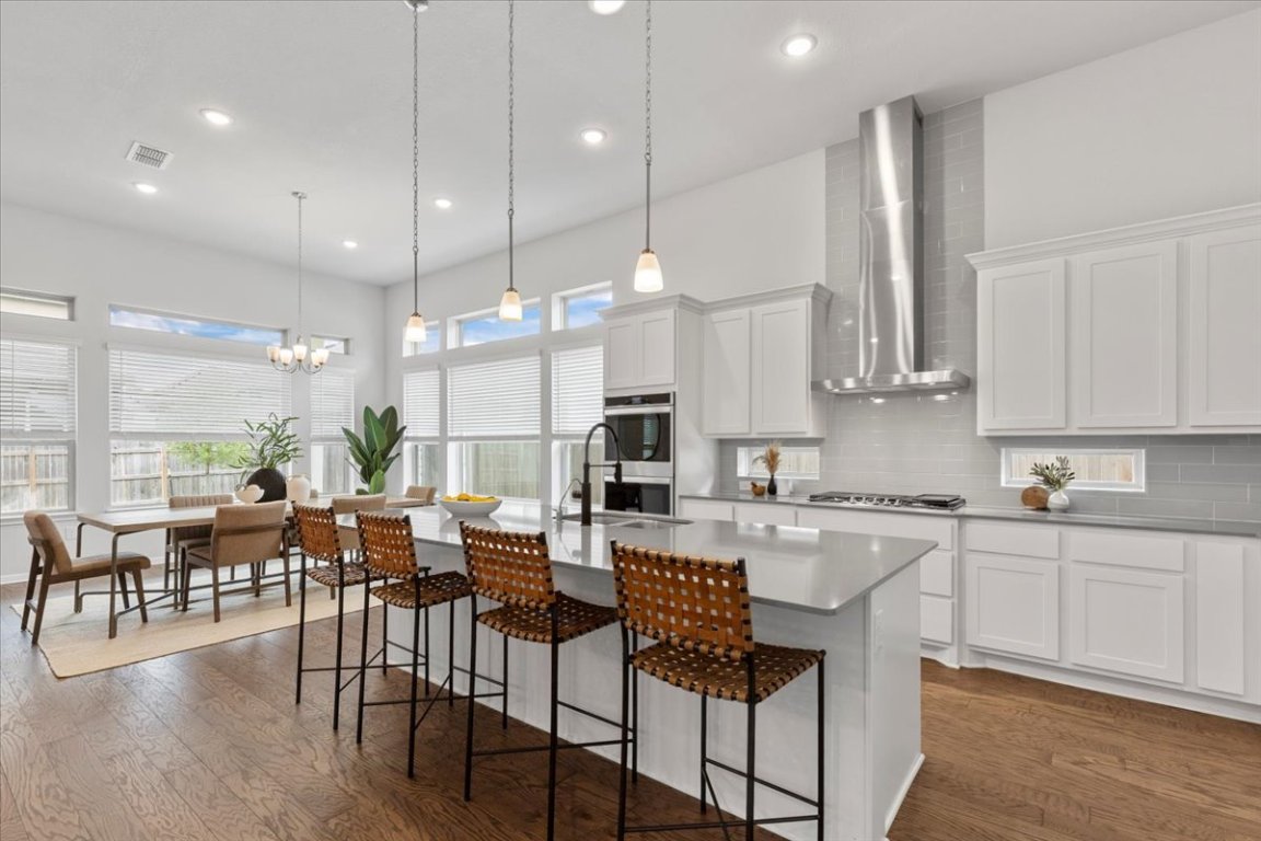 271 Eclipse Drive Austin, TX 78737 - Photo 6 of 39 a large kitchen with lots of furniture a sink a dining table and appliances